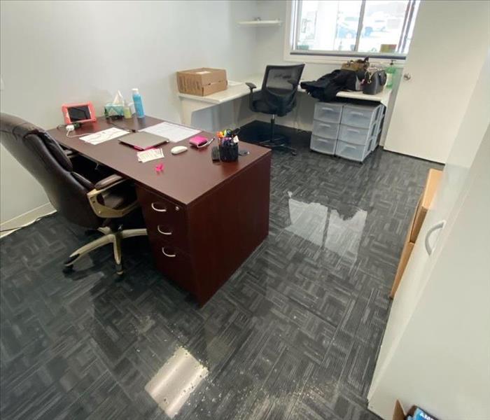 commercial office with water covering the carpet 