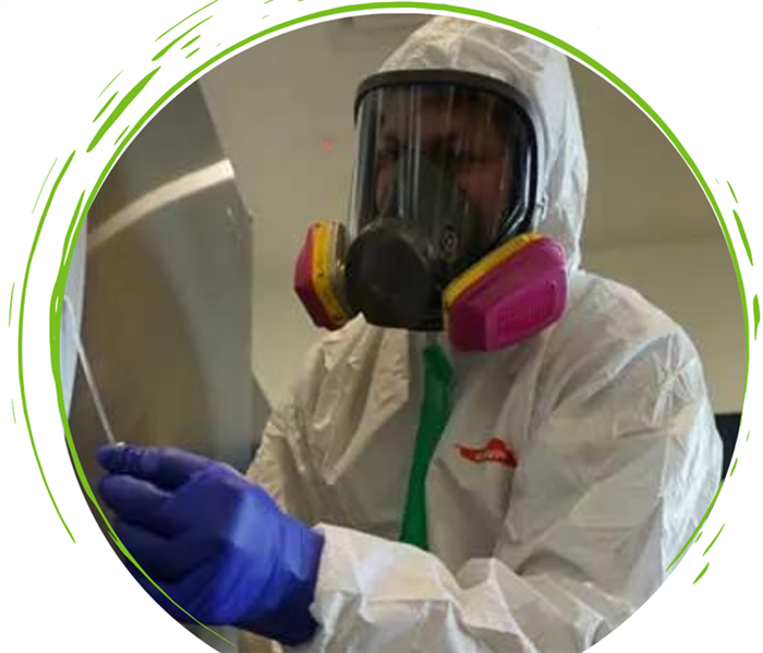 male SERVPRO employee in PPE. Graphic Design on white background with round image.